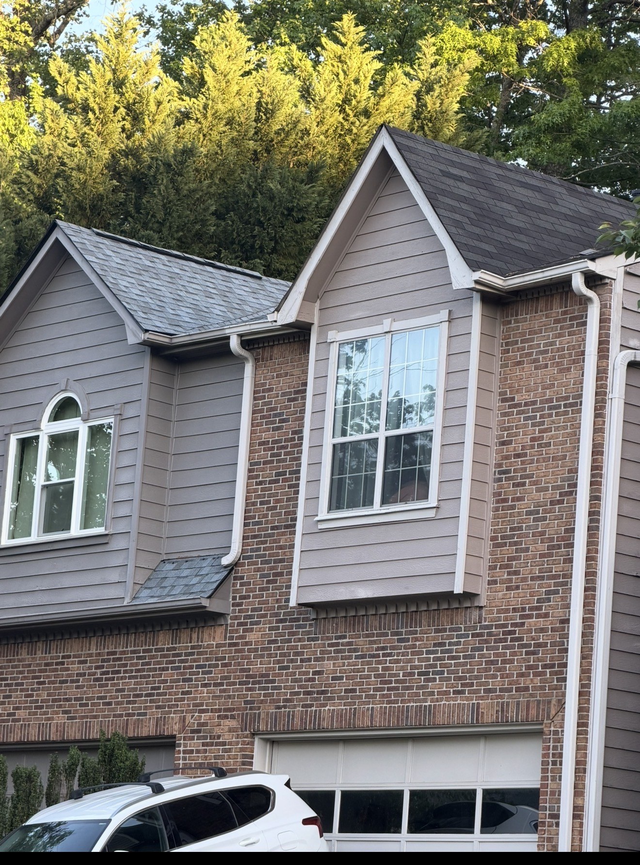 New architectural shingles next to old 3-tab shingles